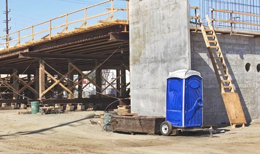 portable restrooms stacked at a busy construction site